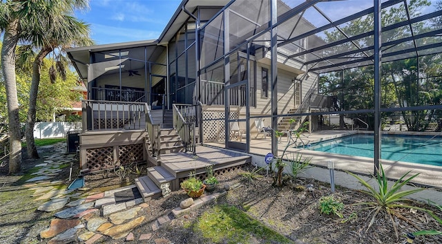 exterior space with a fenced in pool, a ceiling fan, glass enclosure, stairs, and fence