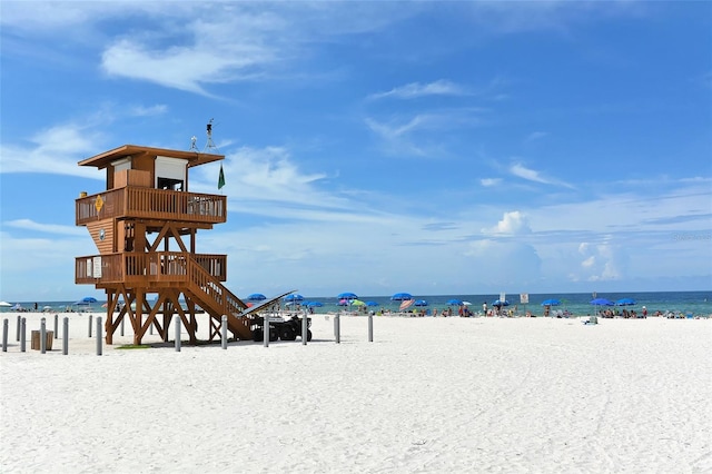 view of property's community with a beach view and a water view