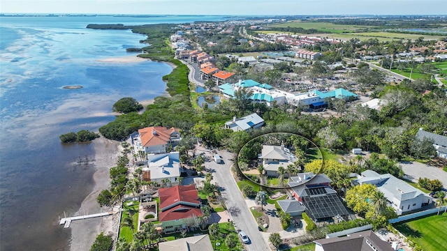 drone / aerial view with a residential view and a water view