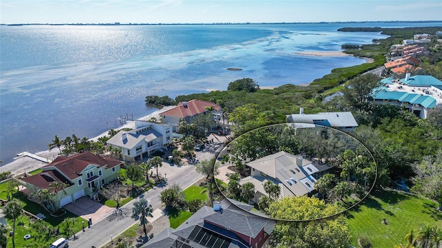 birds eye view of property with a water view and a residential view