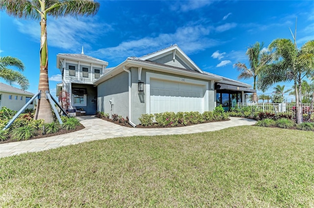 view of front of home with a garage and a front lawn