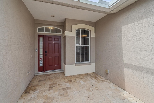 property entrance featuring stucco siding