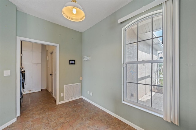 empty room featuring visible vents and baseboards