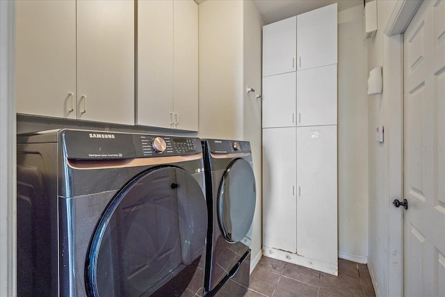 laundry room with washing machine and dryer, tile patterned flooring, and cabinet space