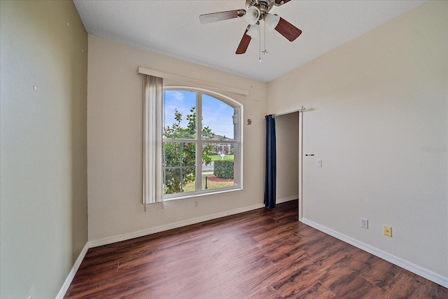 empty room with ceiling fan, baseboards, and wood finished floors