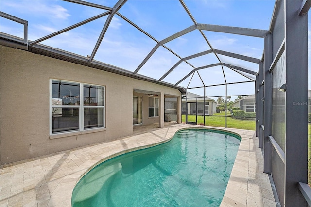 pool featuring glass enclosure and a patio