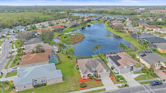 drone / aerial view featuring a water view and a residential view