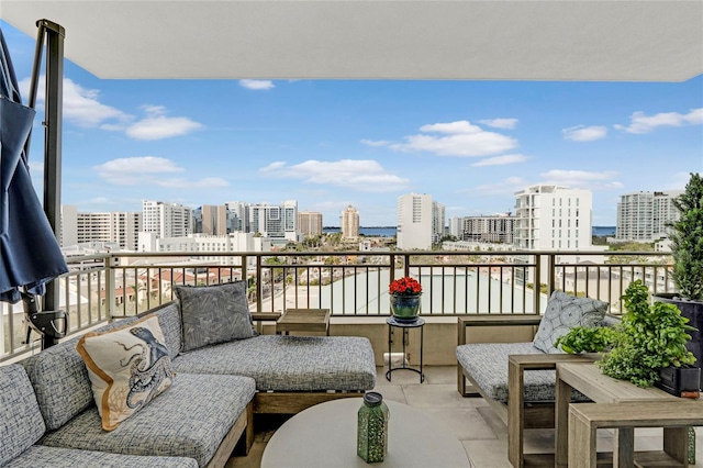 balcony with outdoor lounge area and a city view