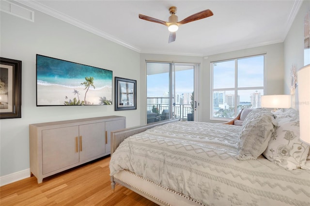 bedroom with visible vents, baseboards, access to exterior, light wood-type flooring, and crown molding