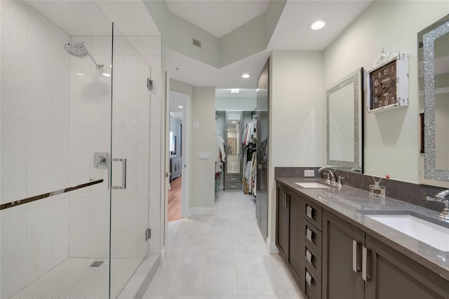 bathroom featuring a shower stall, visible vents, and a sink