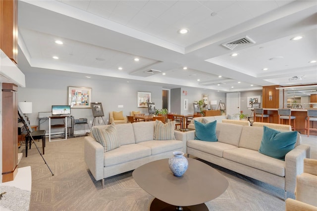 living area with light colored carpet, visible vents, and recessed lighting