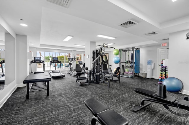 exercise room with visible vents and baseboards