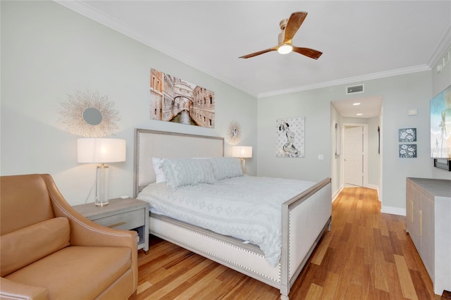 bedroom with baseboards, visible vents, wood finished floors, and ornamental molding