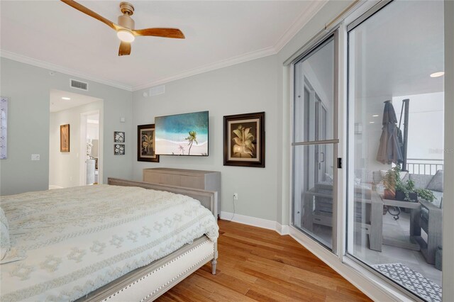 bedroom with baseboards, crown molding, visible vents, and wood finished floors