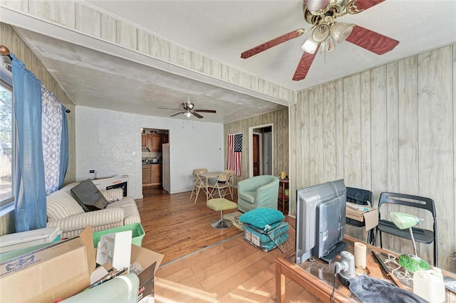 living room with ceiling fan and wood-type flooring