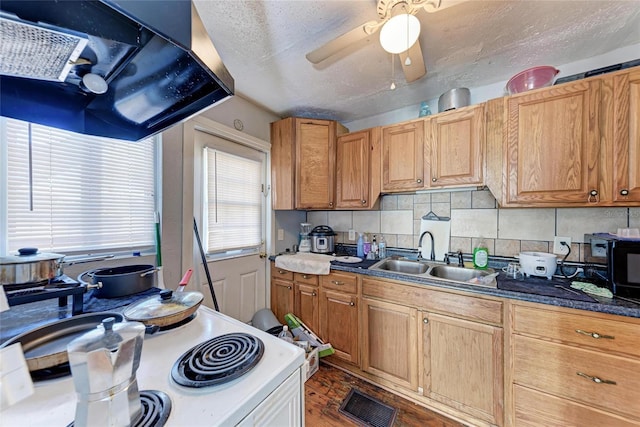 kitchen featuring sink, backsplash, white electric range, and a textured ceiling