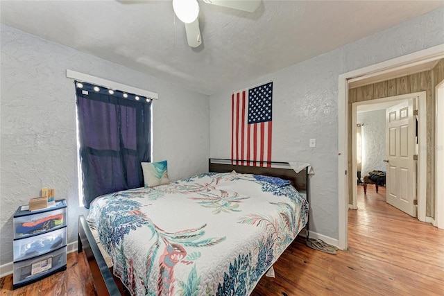 bedroom featuring hardwood / wood-style flooring and ceiling fan