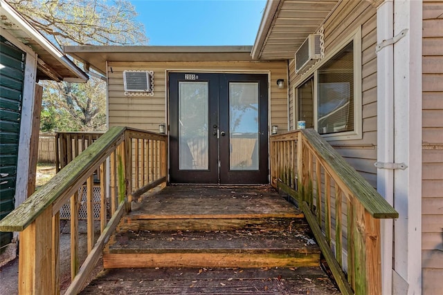 entrance to property with an AC wall unit and french doors