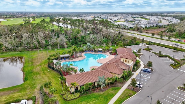 birds eye view of property with a water view, golf course view, and a residential view