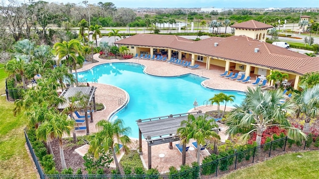 community pool featuring a pergola, fence, and a patio