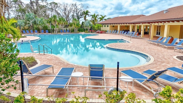 pool featuring a patio area and fence