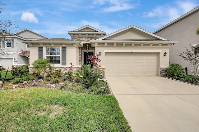 view of front of property featuring stone siding, stucco siding, and driveway