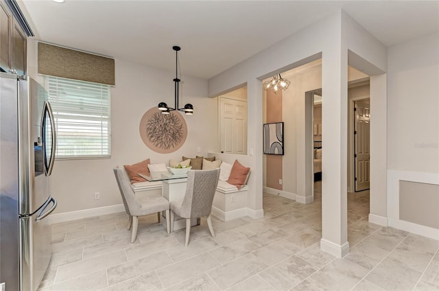 dining space with a chandelier and breakfast area