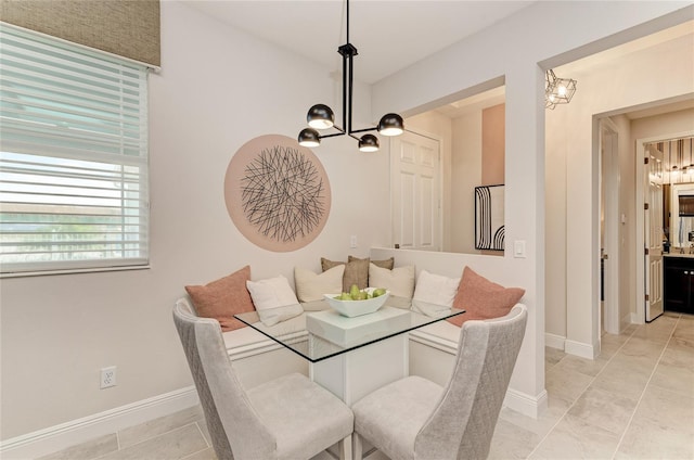 dining space featuring breakfast area and a notable chandelier