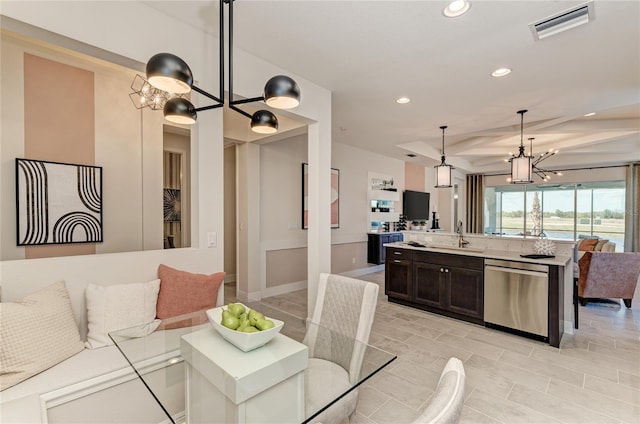 dining area featuring sink and an inviting chandelier