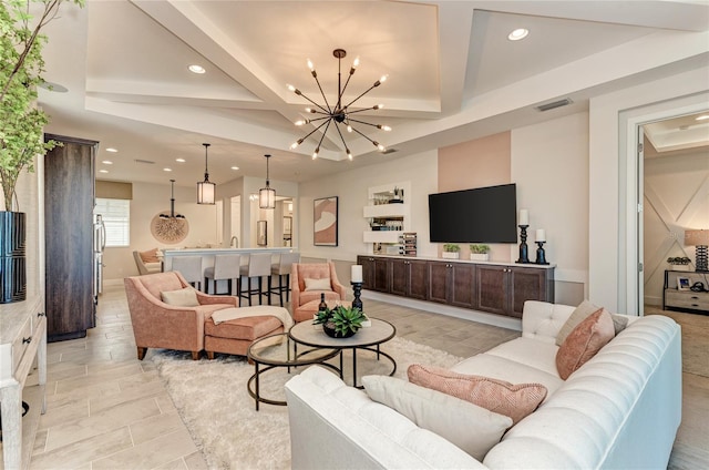 living room featuring coffered ceiling, sink, beamed ceiling, and a notable chandelier