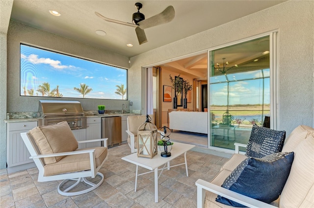 view of patio with ceiling fan, exterior kitchen, and grilling area