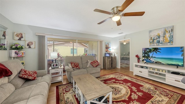 living area with ceiling fan and wood finished floors