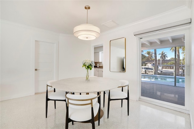 dining area featuring light speckled floor and crown molding