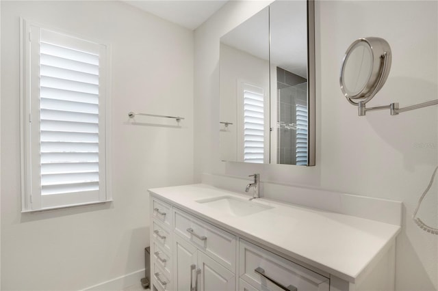 bathroom with baseboards and vanity