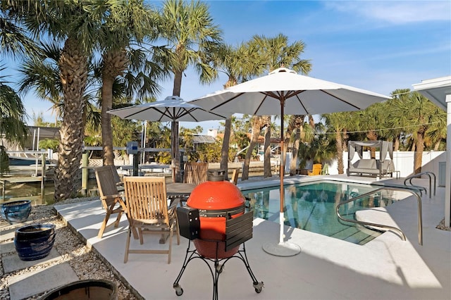 view of swimming pool with a patio area, fence, and a fenced in pool