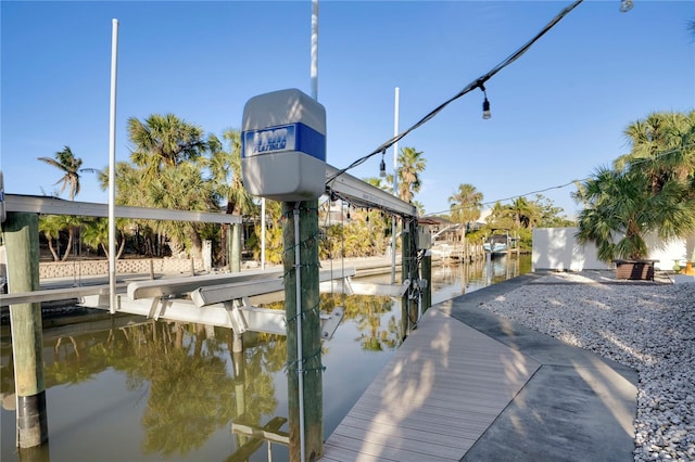 dock area with a water view and boat lift