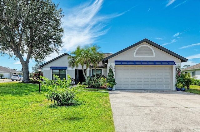 ranch-style home with stucco siding, a front yard, an attached garage, and driveway