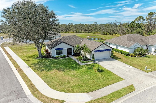 single story home with a garage, driveway, and a front yard