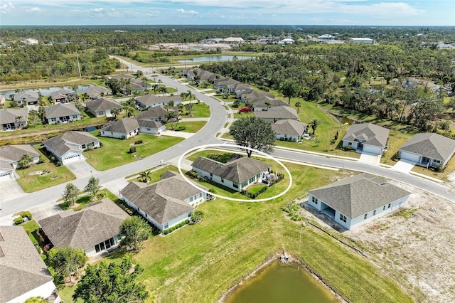 birds eye view of property featuring a view of trees, a water view, and a residential view