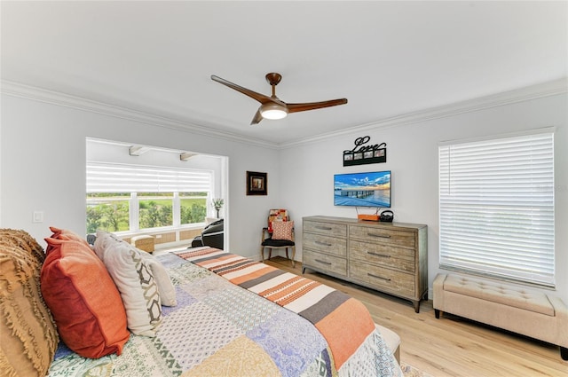 bedroom featuring light wood finished floors, a ceiling fan, and ornamental molding