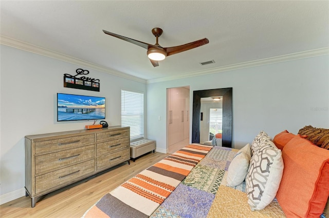 bedroom with baseboards, multiple windows, light wood-style flooring, and ornamental molding