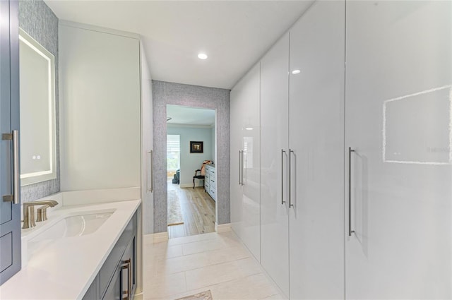 ensuite bathroom with vanity, tile patterned floors, a stall shower, and ensuite bath