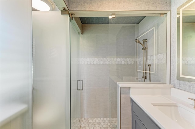 full bathroom with vanity and a shower stall