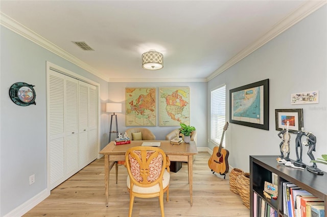 living area with visible vents, baseboards, light wood-style floors, and ornamental molding