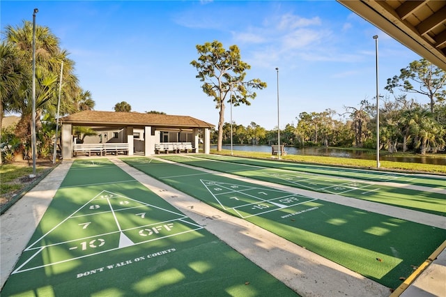 surrounding community featuring a water view and shuffleboard