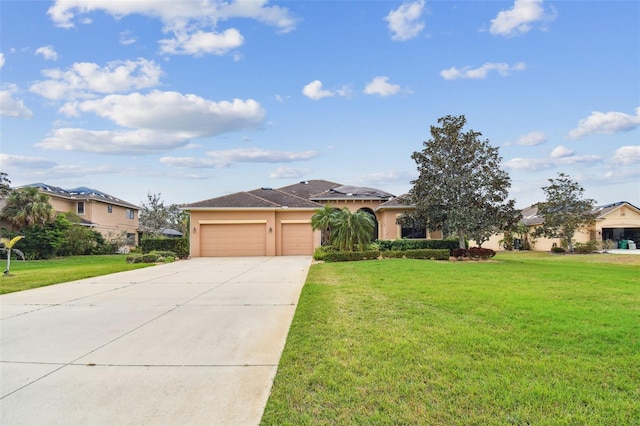 view of front of property with a garage, a front yard, concrete driveway, and stucco siding