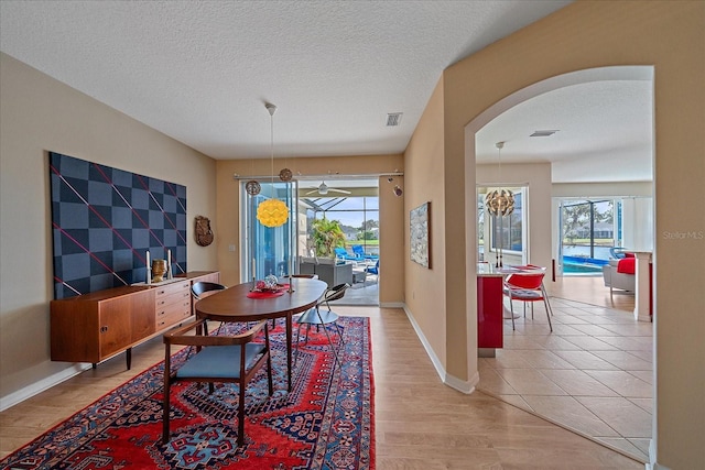 dining room with wood-type flooring and a textured ceiling