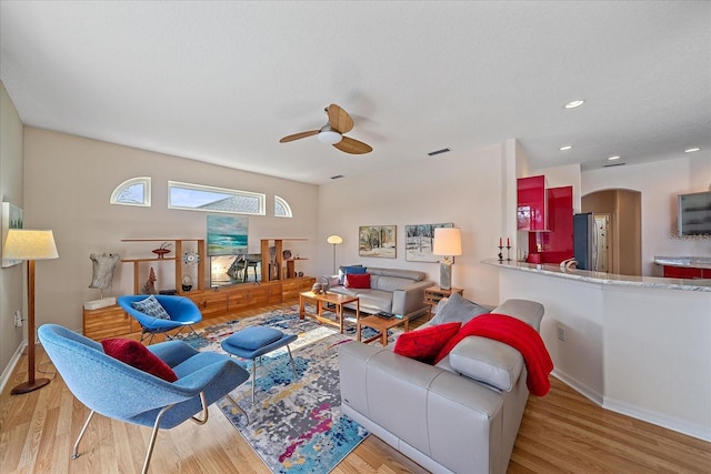 living room featuring ceiling fan and light wood-type flooring