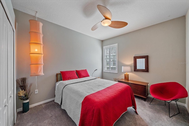 carpeted bedroom featuring ceiling fan, a textured ceiling, and a closet