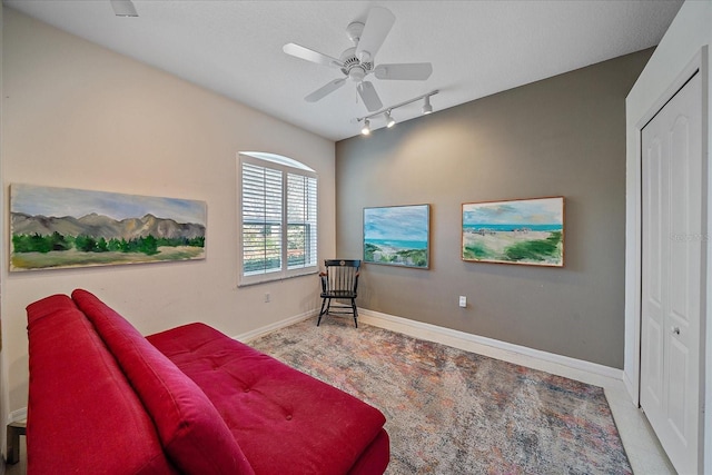 sitting room featuring ceiling fan and rail lighting